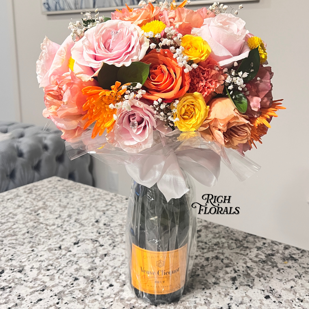 Champagne bottle with floral arrangement by Rich Florals, Woodbridge NJ