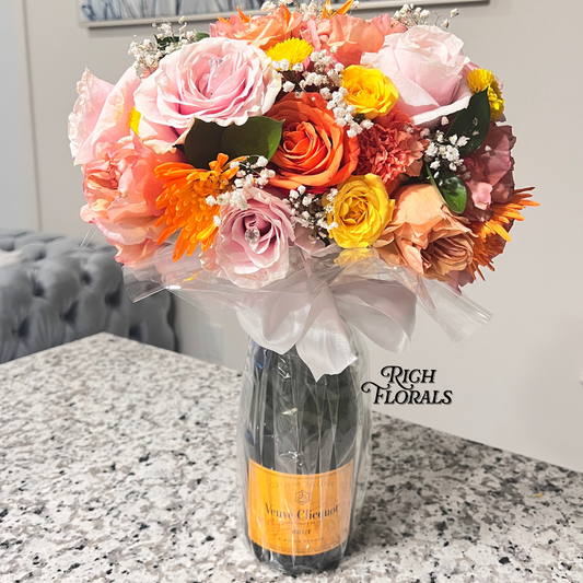 Champagne bottle with floral arrangement by Rich Florals, Woodbridge NJ